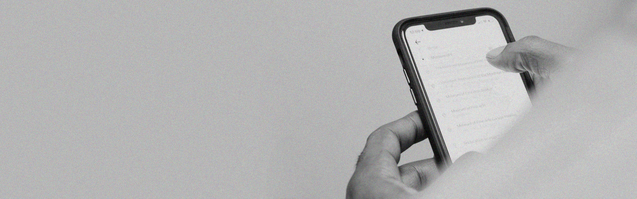 A black and white rendering of a person's hands scrolling on a phone.